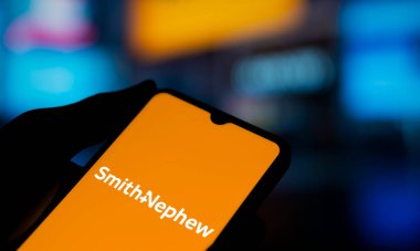 Dhaka, Bangladesh- 5 Dec 2024: Smith Nephew logo is displayed on smartphone.Smith+Nephew is a British multinational medical equipment manufacturing company. clipart