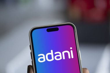 Dhaka, Bangladesh- 0 Dec 2024: Adani logo is displayed on smartphone. Adani Group is an Indian multinational company. clipart