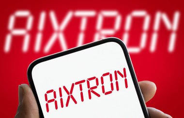 Dhaka, Bangladesh- 11 Dec 2024: AIXTRON logo is displayed on smartphone. Aixtron SE is a European multinational technology company. clipart