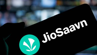 Dhaka, Bangladesh- 8 Jan 2025: JioSaavn logo is displayed on smartphone. JioSaavn is an Indian music streaming service. clipart