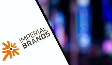 Dhaka, Bangladesh- 15 Dec 2024: imperial brands logo is displayed on smartphone. Imperial Brands plc is a British multinational tobacco company. clipart