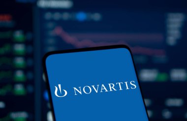 Dhaka, Bangladesh- 29 Dec 2024: Novartis logo is displayed on smartphone. Novartis AG is a Swiss multinational pharmaceutical corporation. clipart