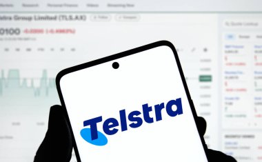 Dhaka, Bangladesh- 31 Dec 2024: Telstra logo is displayed on smartphone. Telstra Group Limited is an Australian telecommunications company. clipart