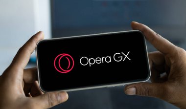 Dhaka, Bangladesh- 27 Nov 2024: Opera gx logo is displayed on smartphone. Opera GX is a gaming-oriented alternative to Opera. clipart