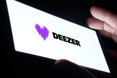 Dhaka, Bangladesh- 20 Jan 2025: deezer logo is displayed on smartphone. Deezer is a French music streaming service. clipart