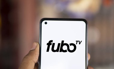 Dhaka, Bangladesh- 20 Jan 2025: fubo tv logo is displayed on smartphone. FuboTV is an American streaming television service company. clipart