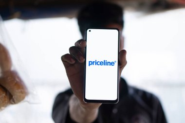 Dhaka, Bangladesh- 20 Jan 2025: priceline logo is displayed on smartphone. is an online travel agency for  discount  for travel  airline tickets and hotel stays company. clipart