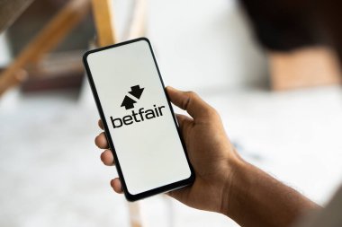 Dhaka, Bangladesh- 11 Jan 2025: betfair logo is displayed on smartphone. Betfair is a British gambling company. clipart