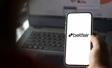 Dhaka, Bangladesh- 11 Jan 2025: betfair logo is displayed on smartphone. Betfair is a British gambling company. clipart