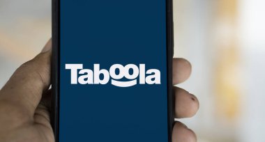 Dhaka, Bangladesh- 19 Jan 2025: taboola logo is displayed on smartphone. Taboola Inc is a publicly traded advertising and technology company. clipart