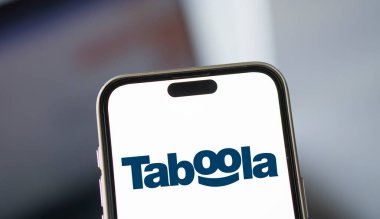 Dhaka, Bangladesh- 19 Jan 2025: taboola logo is displayed on smartphone. Taboola Inc is a publicly traded advertising and technology company. clipart