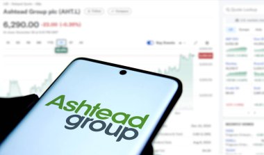 Dhaka, Bangladesh- 1 Dec 2024: Ashtead group logo is displated on smartphone.Ashtead Group Public Limited Company is a British industrial equipment rental company. clipart