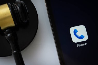 Dhaka, Bangladeş - 16 Mart 2025: Bir yargıcın tokmağının yanında Google uygulaması ile telefonu gösteren iPad ekranının yakın çekimi.