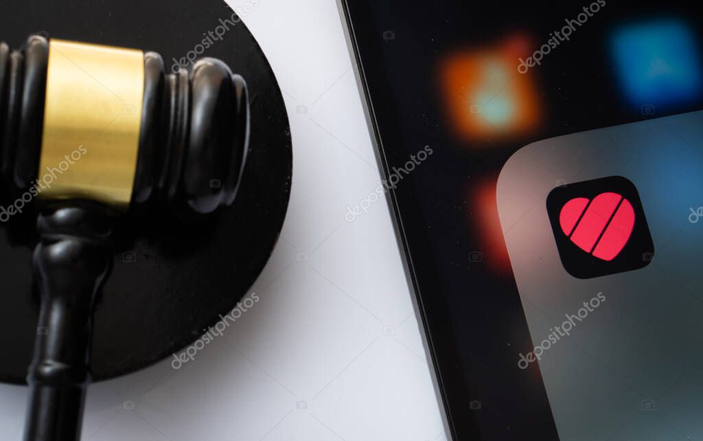 Dhaka, Bangladesh- 17 March 2025: A close up of an iPad screen displaying the likee app alongside a judge's gavel.
