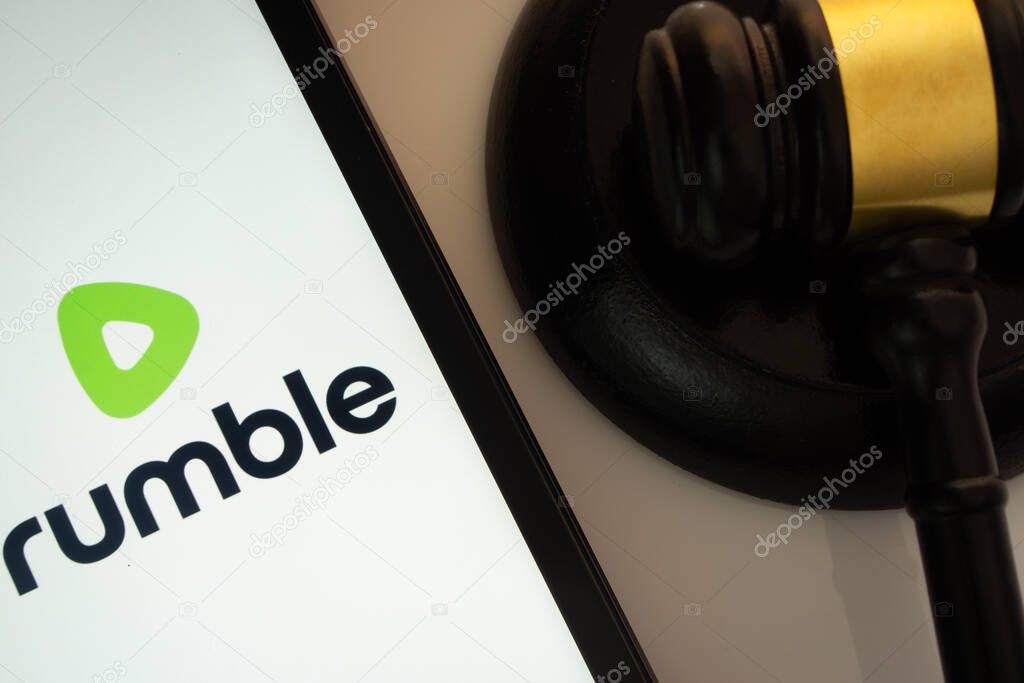 Dhaka, Bangladesh- 18 March 2025: A close up of an iPad screen displaying the rumble app alongside a judge's gavel.