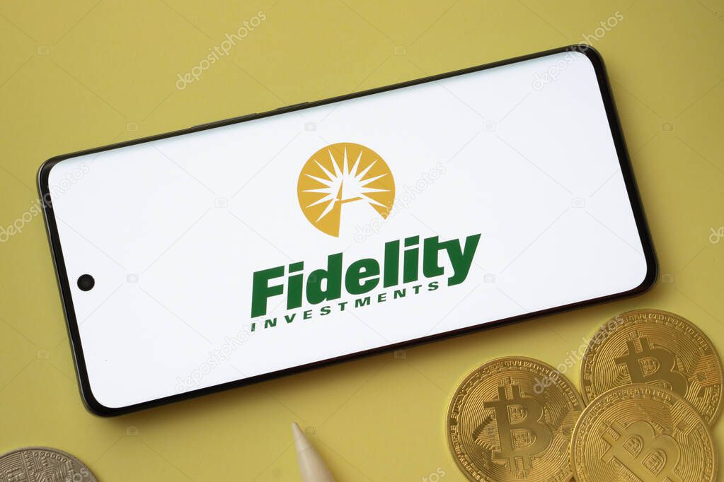 Dhaka, bangladesh- 12 June 2025: Fidelity Investments logo displayed on a smartphone with Bitcoin coins on a yellow background