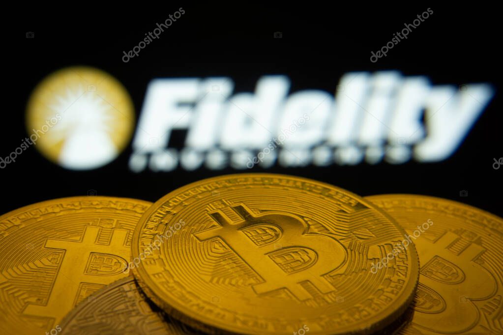Dhaka, Bangladesh- 12 June 2025: Close-up of Bitcoin coins with the Fidelity Investments logo visible on a screen in the background.