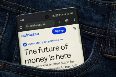 Dhaka, Bangladeş - 15 Haziran 2025: Coinbase.com web arayüzünü gösteren bir akıllı telefon kot pantolon cebinden gözetliyor.