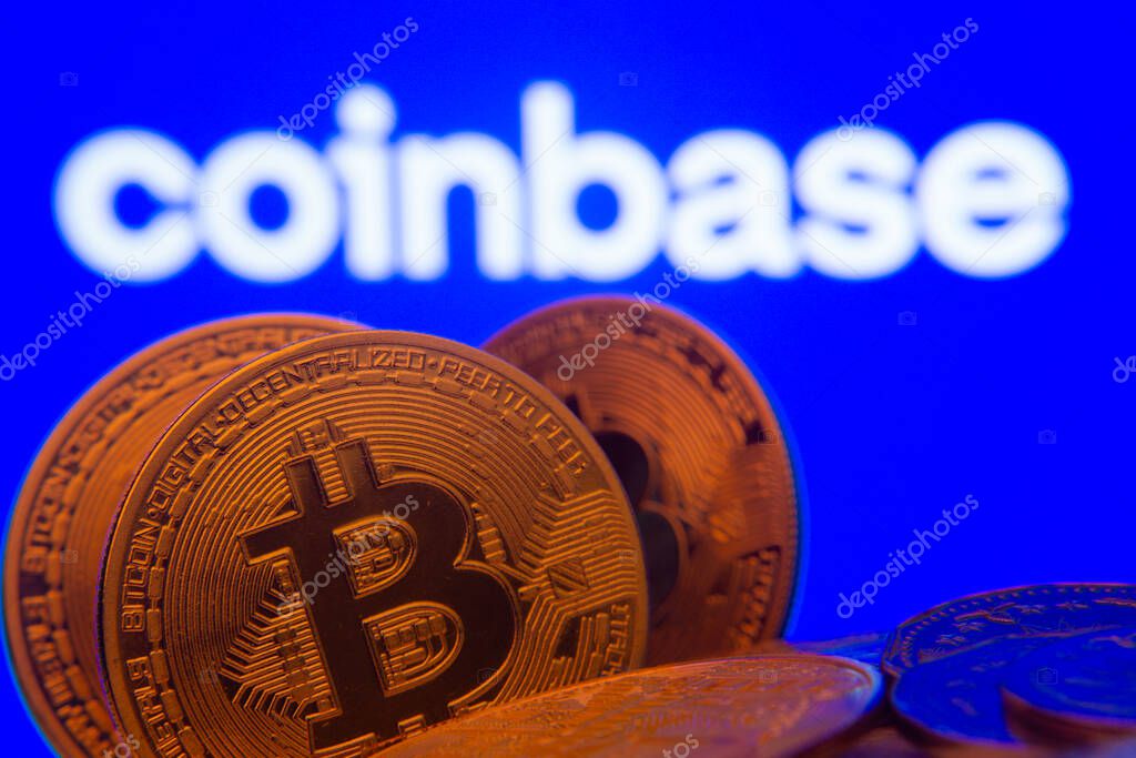 Dhaka, Bangladesh- 16 June 2025: Close-up of Bitcoin coins with the Coinbase logo visible on a screen in the background.