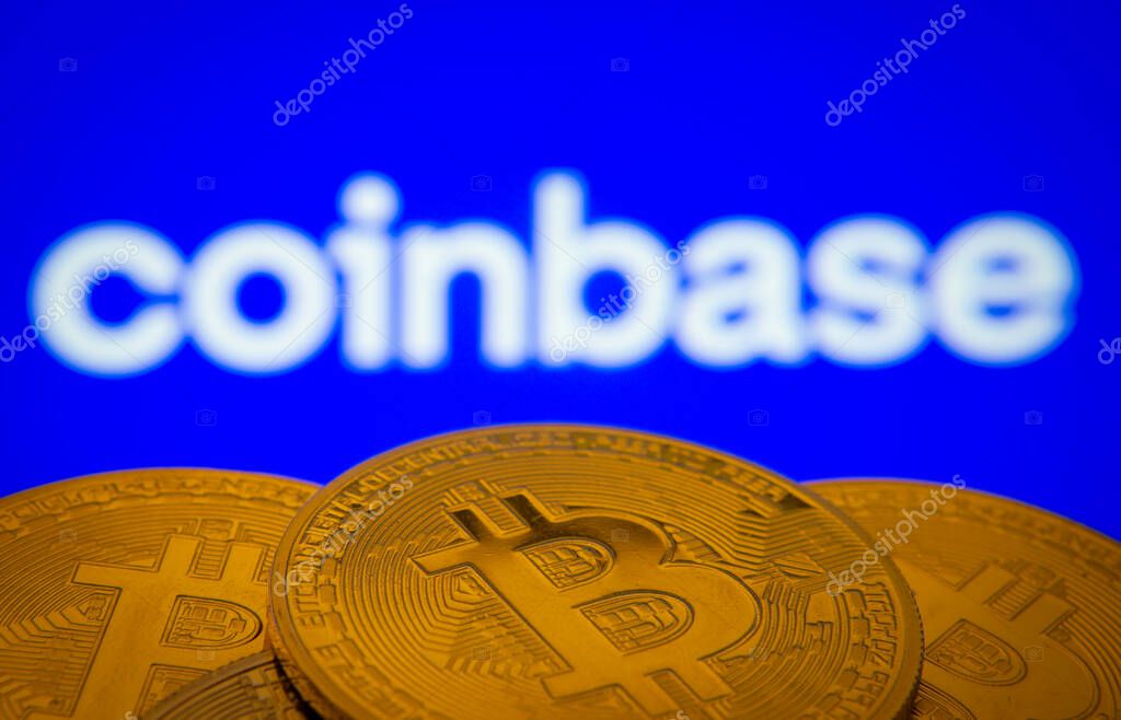 Dhaka, Bangladesh- 16 June 2025: Close-up of Bitcoin coins with the Coinbase logo visible on a screen in the background.