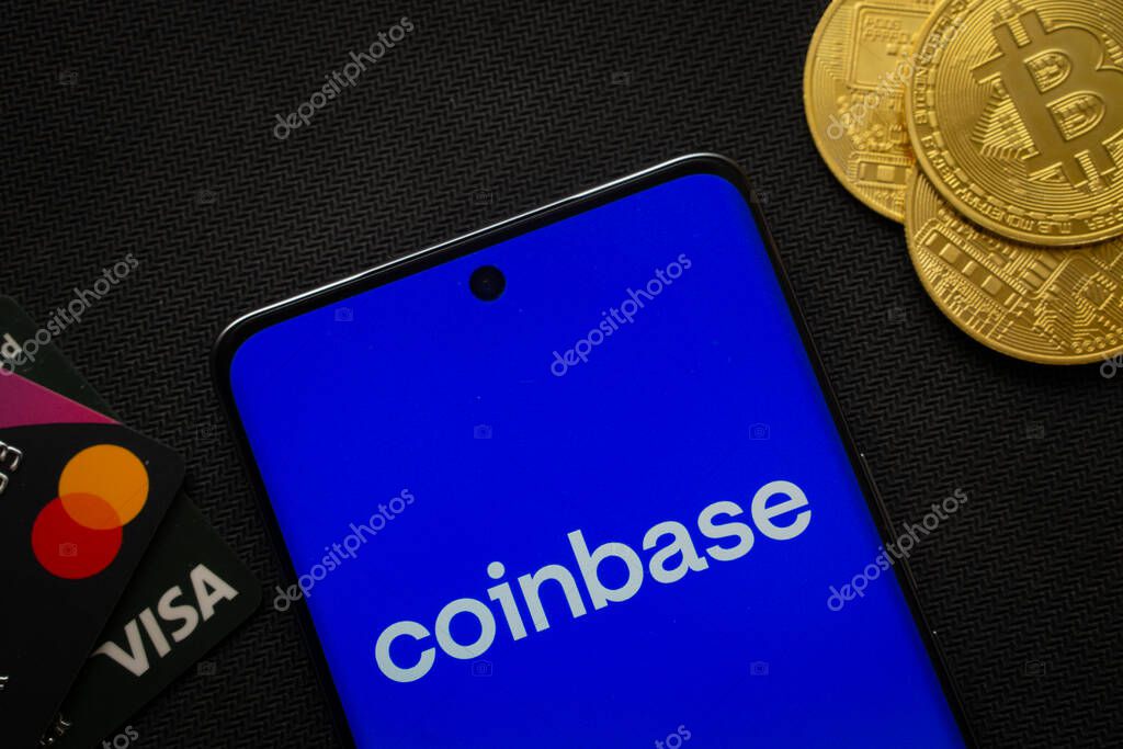 Dhaka, Bangladesh- 17 June 2025: Smartphone displaying Coinbase logo surrounded by Bitcoin coins and payment cards.