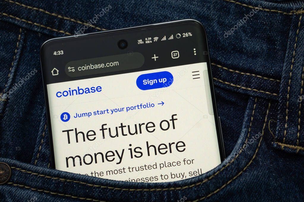 Dhaka, Bangladesh- 15 June 2025: A smartphone displaying the coinbase.com web interface peeks out of a denim pocket.