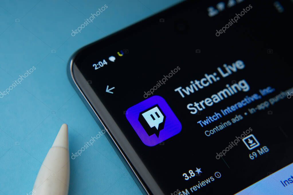 Dhaka, Bangladesh- 30 Sep 2025: On a blue surface, a smartphone displays the Twitch app within the Google Play Store.