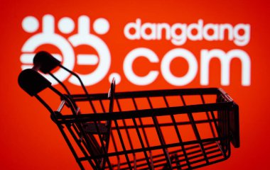Dhaka, Bangladesh- 03 Oct 2025: Silhouette of a shopping cart in front of the Dangdang.com logo, symbolizing ecommerce and online shopping