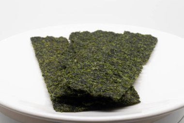 Beyaz bir tabakta istiflenmiş yosun örtülerini kapatın..