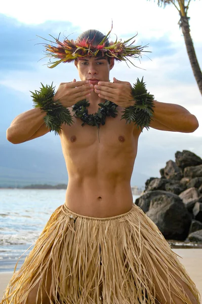 A tradition Male Hula Dance using his hands to gesture a kiss and loving hand movements of Hawaiian Dance.