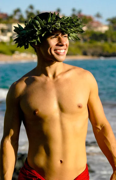 Handsome male Hawaiian Hula Dancer poses for a portrait with a big smile.