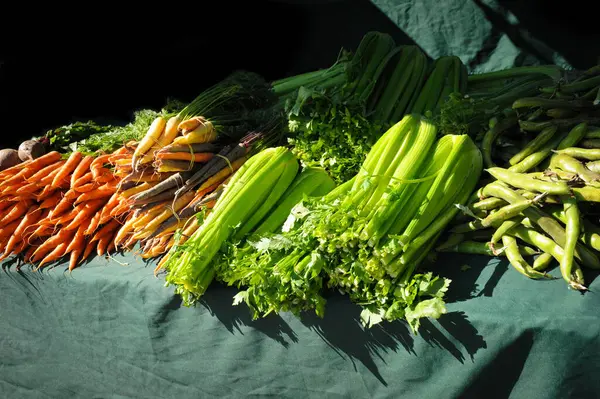 stock image Freshly selected to perfection, the veggies at the farmers market in Danville, Northern California, include bunches of celery, carrots, beets, and green beans. 