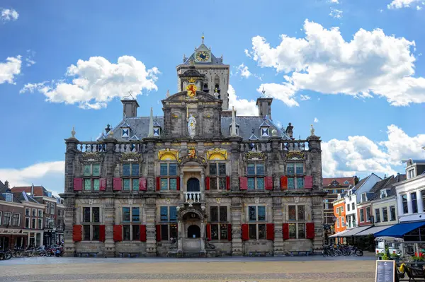 stock image On a beautiful clear day, the Netherlands' Delft Market Place is home to the medieval Delft City Hall.