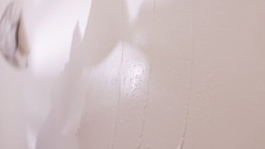 Close up of construction worker applying plaster to a wall