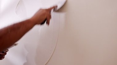 Close up of construction worker applying plaster to a wall