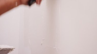 Close up of construction worker applying plaster to a wall