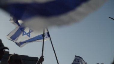 Ulusal İsrail bayrakları sallayan göstericiler