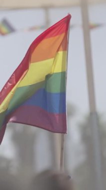 Gurur yürüyüşü sırasında gökkuşağı bayrağının yavaşça dalgalanması.