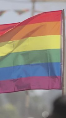 Gurur yürüyüşü sırasında gökkuşağı bayrağının yavaşça dalgalanması.