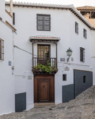 Granada, Endülüs, İspanya 'da sokak lamba direği ve binası olan bir kaldırım taşı caddesi.