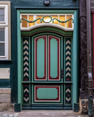 Beautiful old colorful wooden door on the facade of the medieval building clipart