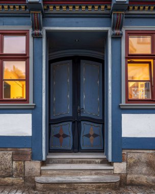 Beautiful old colorful wooden door on the facade of the medieval building clipart