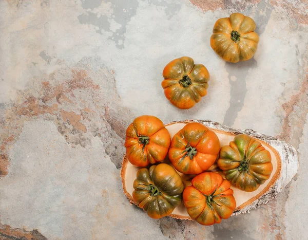 stock image A group of Costoluto big tomatoes on a grey background, rustic concept, stock photo