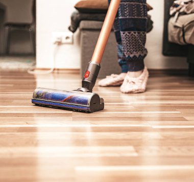 Yerleri temizleyen kadın elektrikli süpürge kullanıyor, ev işi, yakın çekim.