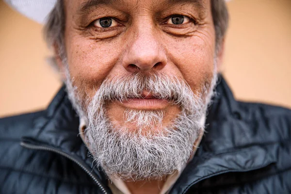 stock image Portrait of a confident, handsome, mature man, pensioner, grandfather in the small town