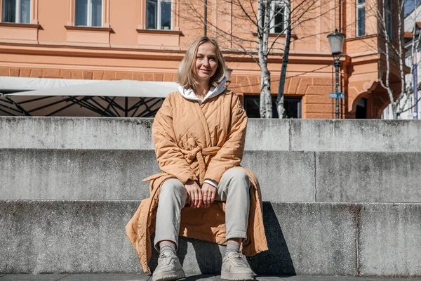 stock image A beautiful young stylish woman walking in the city. Spring mood, dreaming and waiting, a lifestyle concept