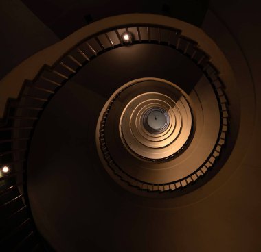 Uzun, çok katlı bir evdeki spiral merdiven 