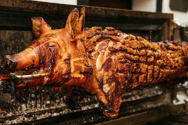 Detailed view of a roasted pig\'s skin on a spit