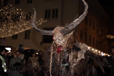 Villach, Austria - 11.29.2024: Processions of the terrible Krampus at the famous Krampuslauf in Villach clipart