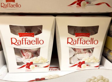 Raffaello candy boxes displayed on shelf in grocery store. clipart